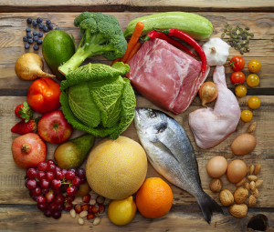 Various Paleo diet products on wooden table, top view